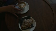 stirring cappuccino in a cafe 