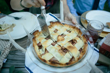 cutting a pie at a table 