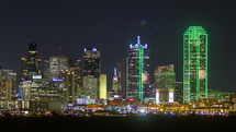 Timelapse of downtown traffic at night near the Dallas skyline.
