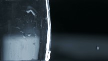 water dropping into a glass of water