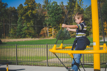 a boy child on playground equipment 