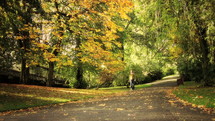 woman walk on a park trail in autumn 