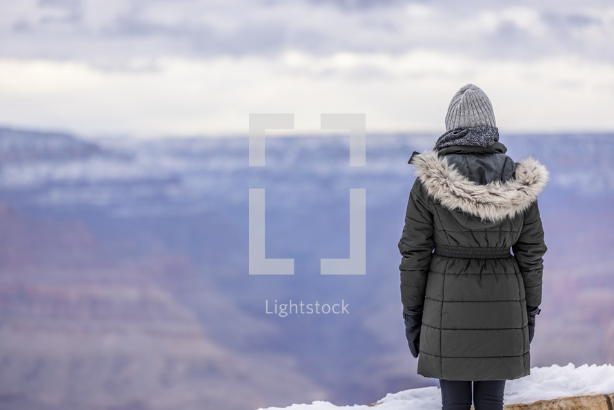 Woman in a parka in the Grand Canyon