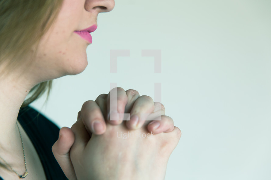 woman with praying hands 