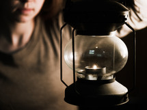 a girl holding a lantern 