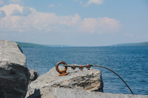 a metal hook in rock along a shore and cable for docking a boat 