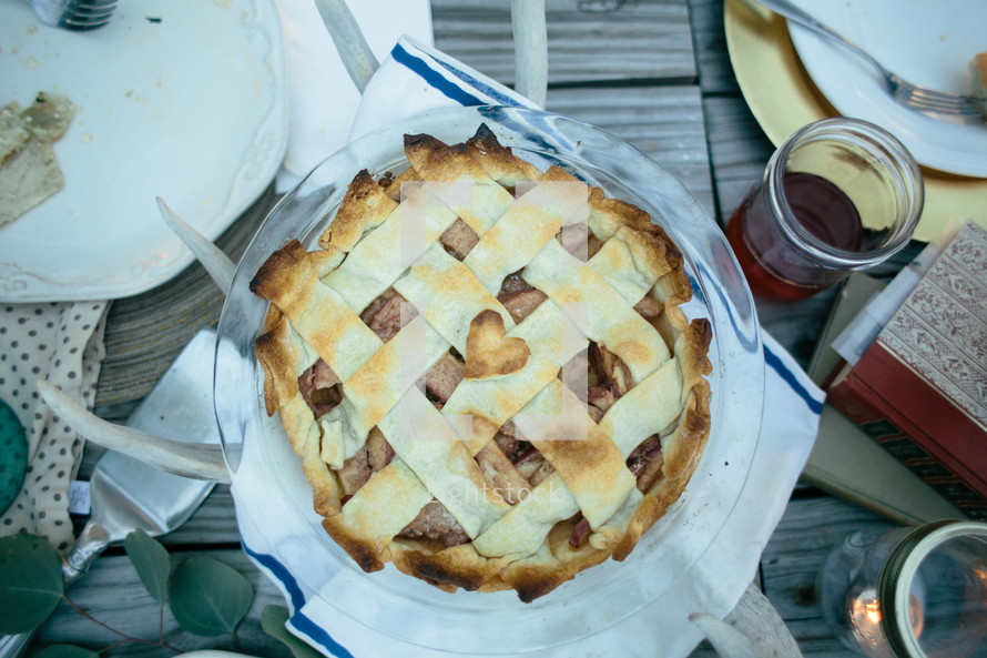 Apple pie on a picnic table.