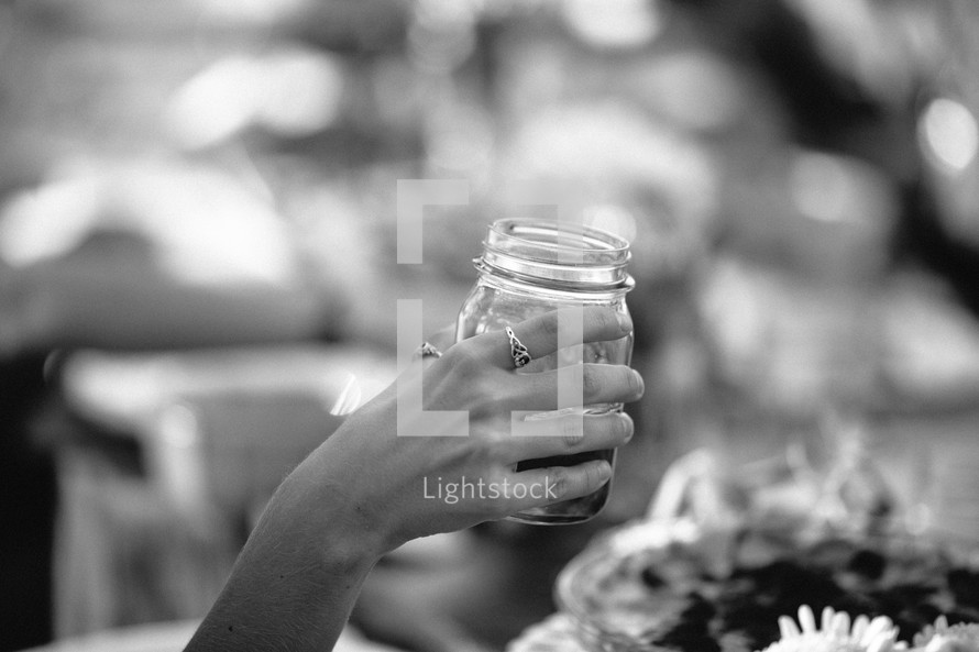 woman holding a mason jar glass 