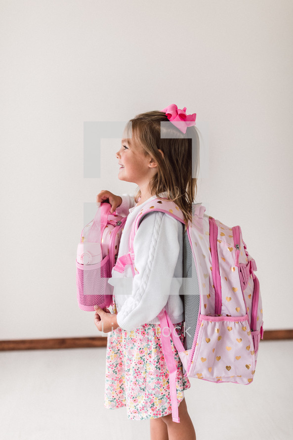girl with a lunchbox and book bag 