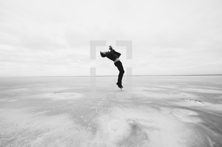 a man leaping in the air over the great salt plains in Oklahoma 