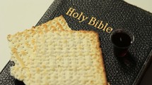 communion bread and wine on a Bible 