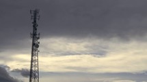 clouds moving and a communication tower