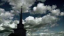Cloud movement over the steeple of a church.
