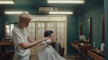 Asian Barber Cleaning Neck of Male Client with Towel