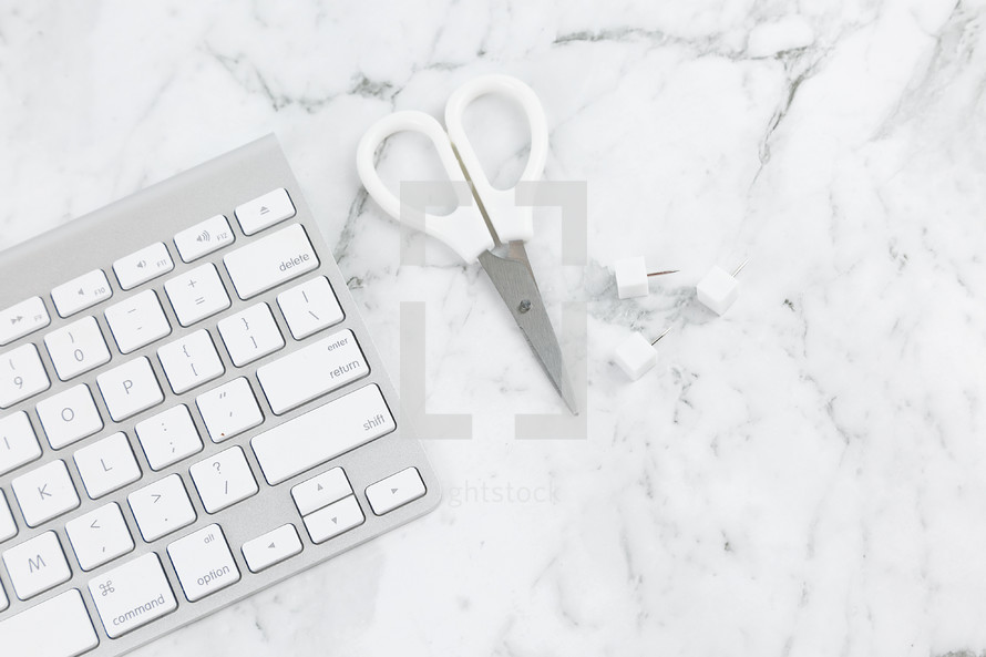 computer keyboard, scissors, clips, on marble 