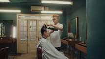 Barber Drying Hair of Male Client after Giving Haircut