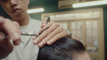 Barber Using Shears and Comb for Giving a Haircut