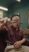 Barber Showing Hairdressing Scissors on Camera