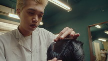 Asian Barber Combing and Parting Hair of Client