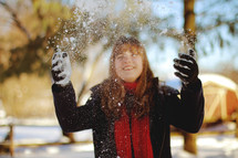 girl throwing snow 