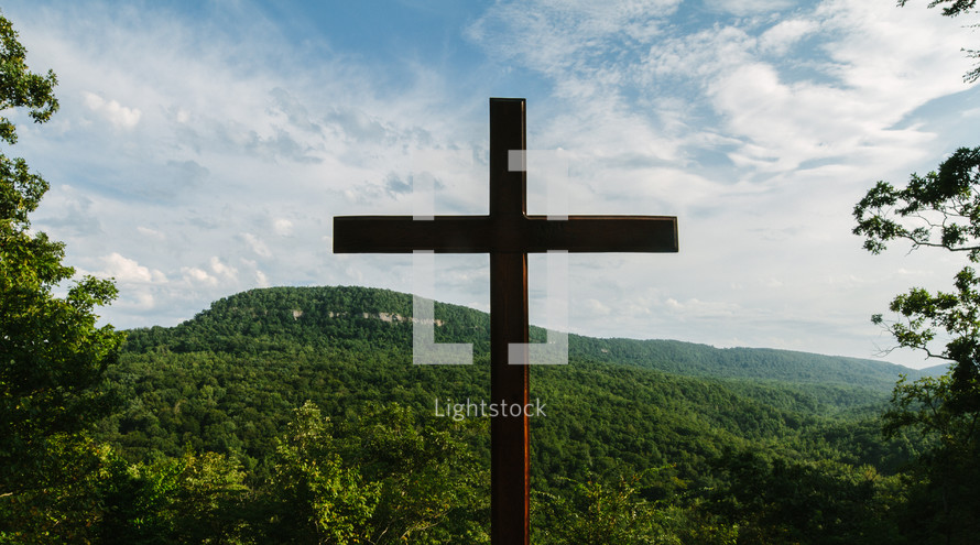 cross against a mountain 