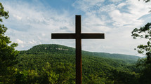 cross against a mountain 