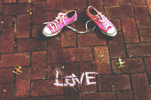 pink converse on bricks and word love in chalk 
