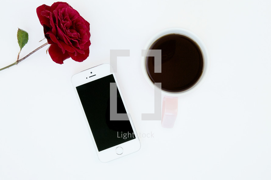 red rose, iPhone, and mug 