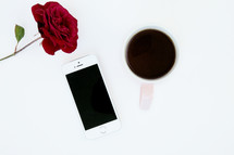 red rose, iPhone, and mug 