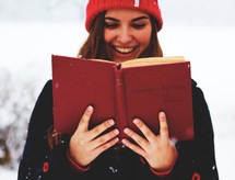 a woman Christmas caroling in the snow 