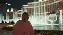 a woman watching the Bellagio fountains Las Vegas 