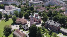 Aerial view circling Orthodox Christian Church of Holy Trinity looking down over green domed rooftop in Banja Luka district
