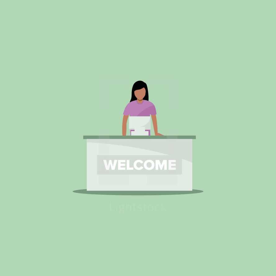 a woman behind a welcome desk 