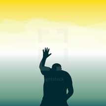 a silhouette of a man praising God 