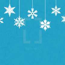 hanging snowflakes on a blue background 