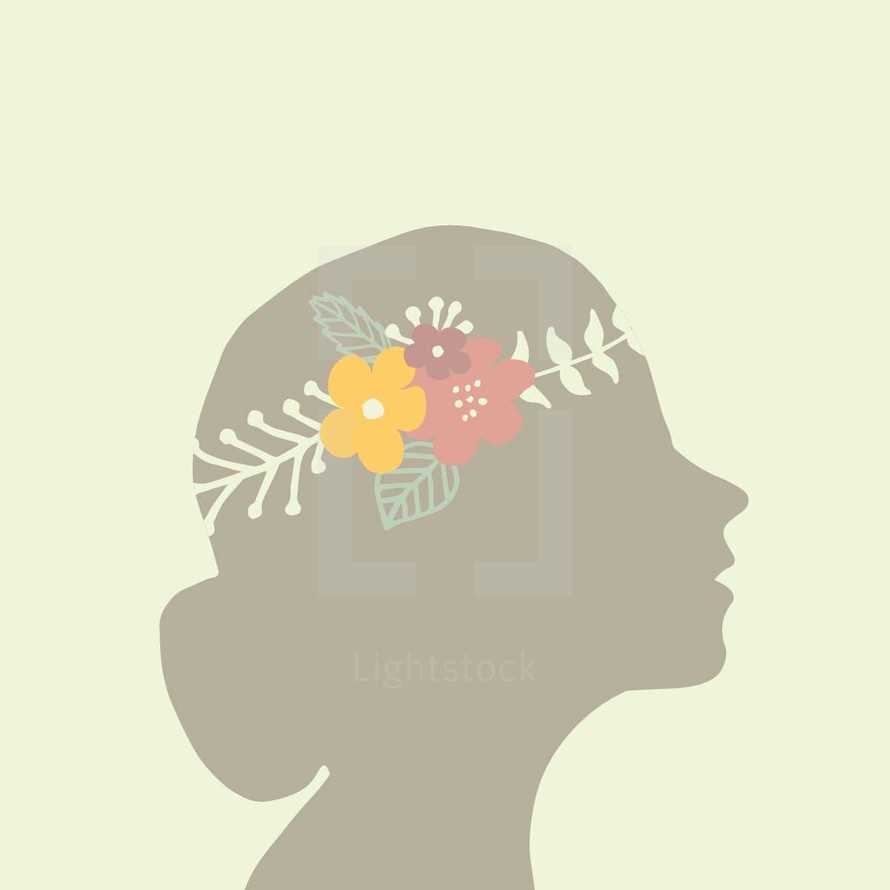 crown of flowers in a woman's head 
