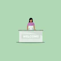 a woman behind a welcome desk 