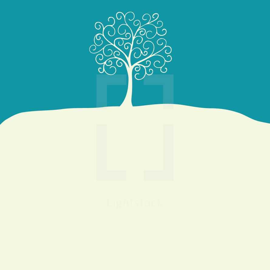 tree on a hill of snow 