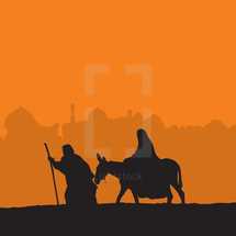 Joseph leading Mary on a donkey 