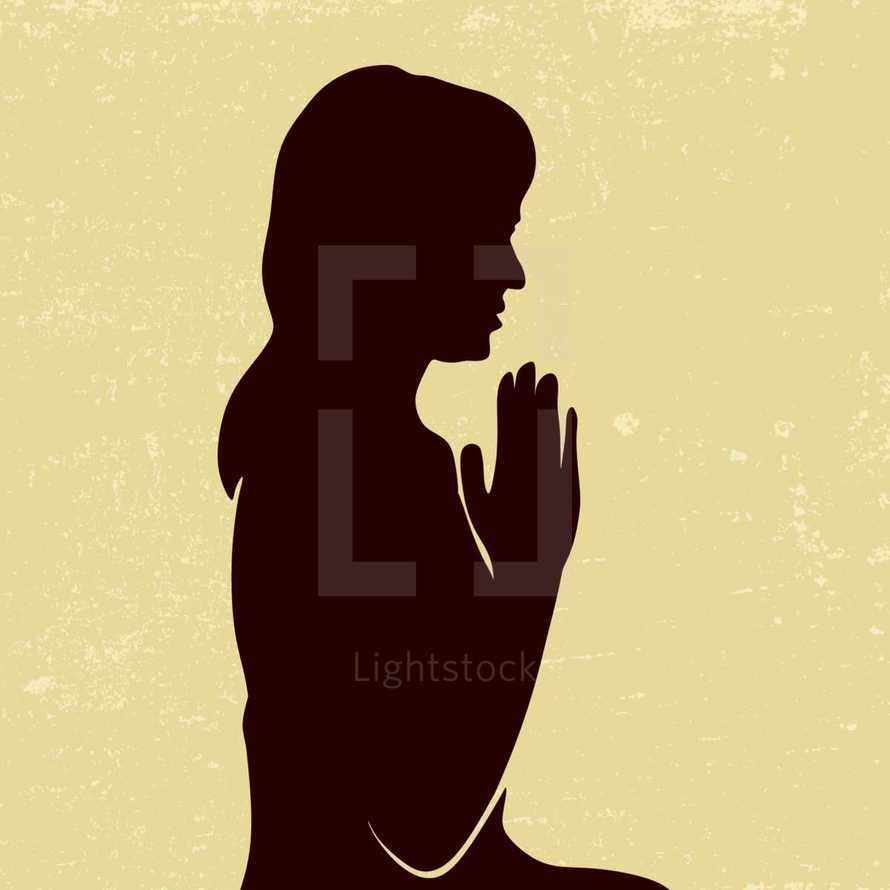 silhouette of a woman with praying hands 