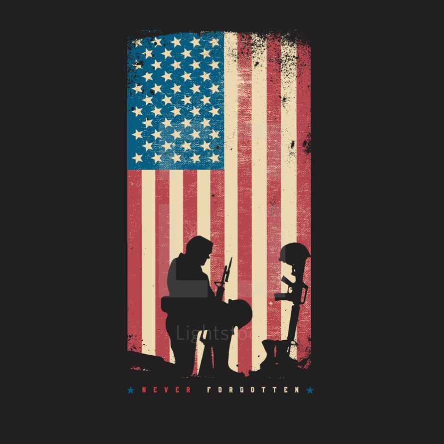Silhouette of a soldier kneeling at the boots, gun, and helmet of a fallen soldier in front of a distressed American flag with Never Forgotten written beneath 
