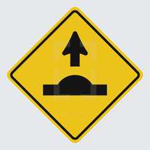 Speed bump ahead street sign 