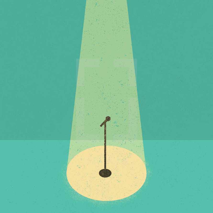 a microphone in the spotlight on stage.
