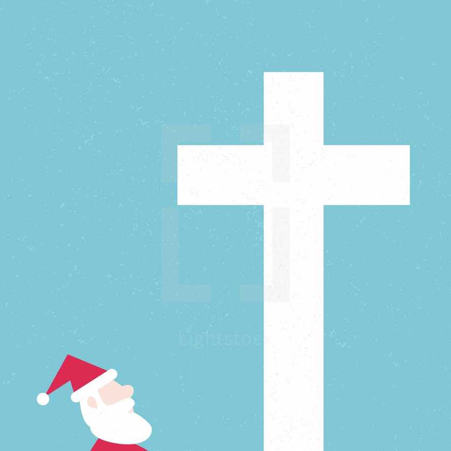 Santa looking up at a cross.