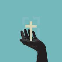 silhouette of hand holding up a cross.