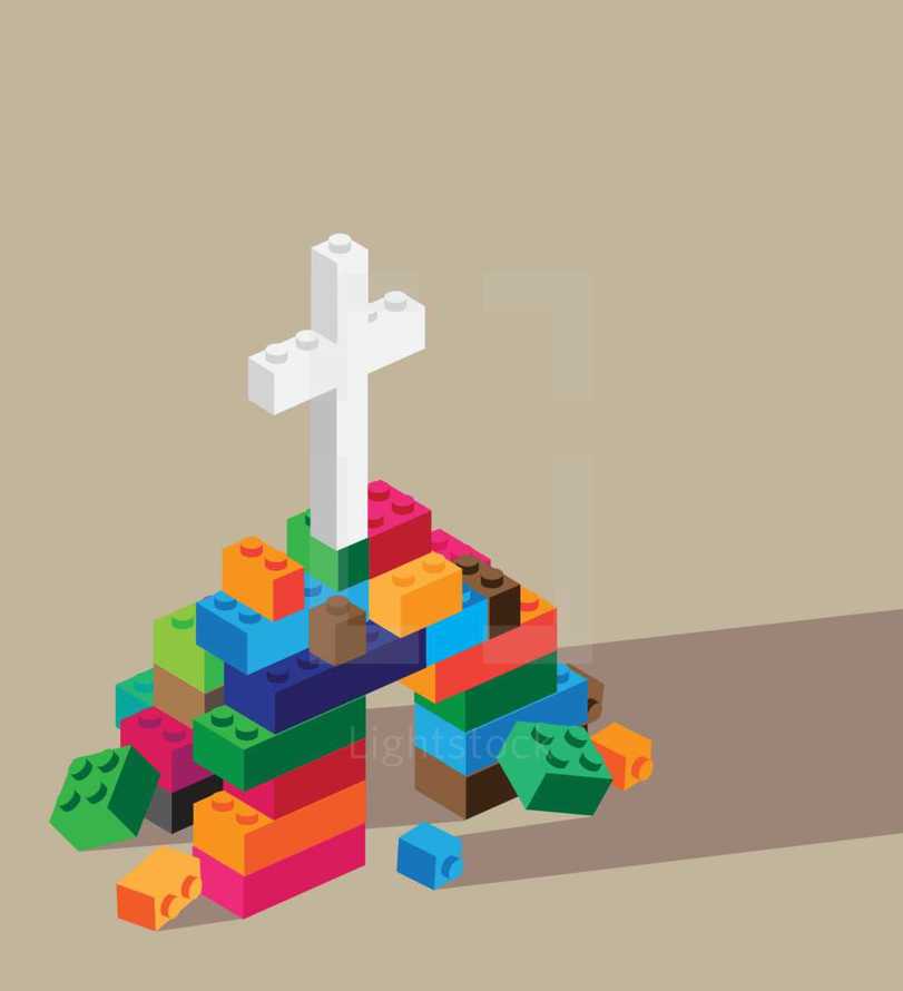 stack of legos and cross 