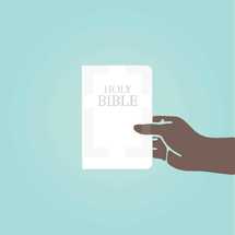 A hand holding a Bible on a blue background.