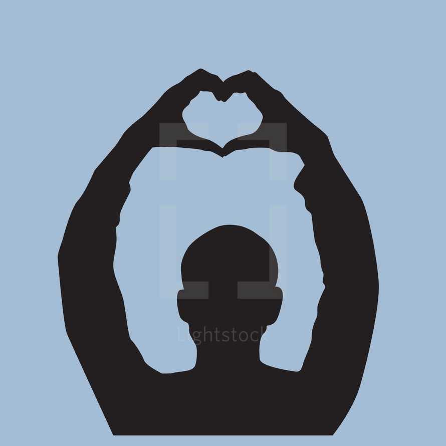 silhouette of a man making a heart shape with his hands 