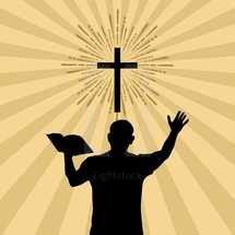 man holding a Bible with a raised hand 