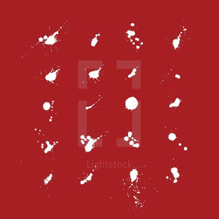 white ink spatters on a red background 